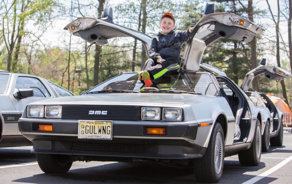 Zachary Loder sits atop his father’s DeLorean DMC-12 at a Mid-Atlantic DeLorean Owners Club show. Photo by: Kevin Abato