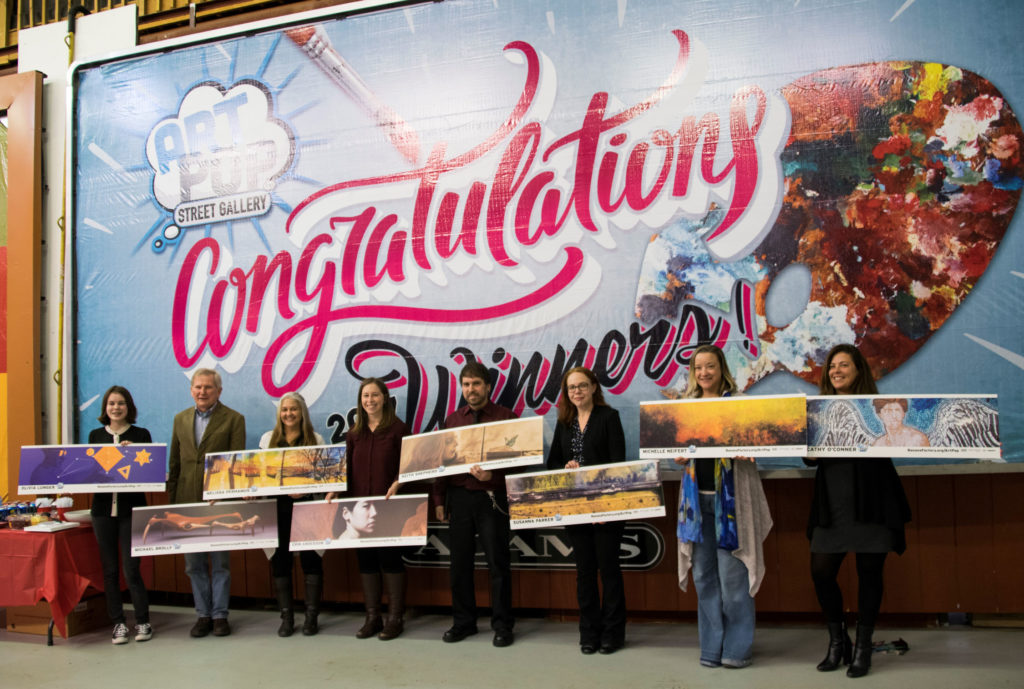  (photo by Danielle Smith of Adams Outdoor Advertising) Adams Outdoor Advertising and ArtsQuest announced the winners of the annual ArtPop billboard competition at a press event Dec. 20, where winners received a billboard mockup of their work. Pictured from left to right are: Olivia Lunger, Michael Brolly, Melissa Perhamus, Erin Anderson, Keith Shepherd, Susanna Parker, Michelle Neifert and ArtPop Executive Director Wendy Hickey, who is holding the artwork for winner Cathy O’Connor.